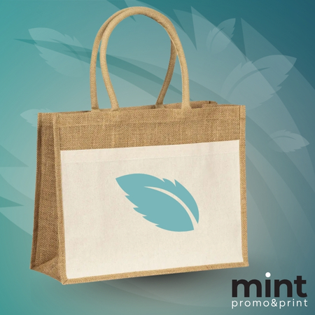 Platneni ceger sa drškama i štampanim plavim listom na beloj površini, na plavoj pozadini